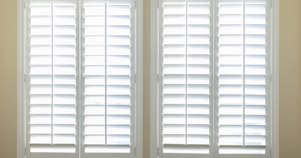 White plantation shutter in two windows